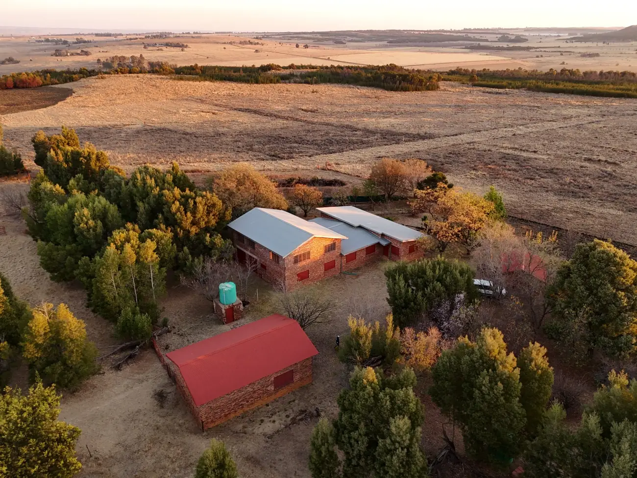 The same homestead seen from higher up, showing how the buildings sit within the full extent of the land.